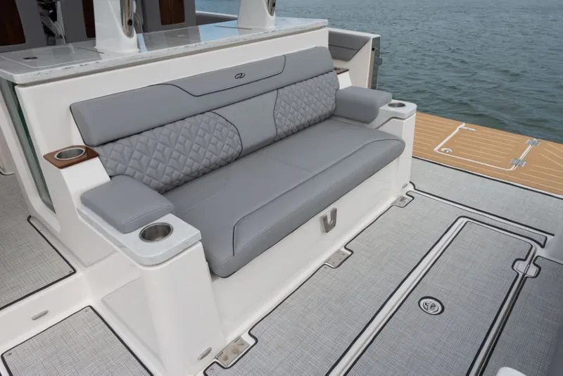 Slide: The Image of Regal 34 SAV 2027: Elegant gray sofa on a modern boat, surrounded by water. - 24