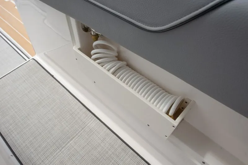 Slide: The Image of A Regal 34 SAV boat with a coiled hose in a compartment. - 27