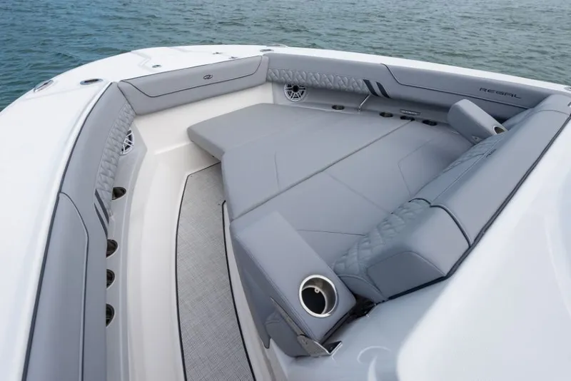 Slide: The Image of The image shows the bow seating area of a Regal 34 SAV boat with gray upholstery. - 34