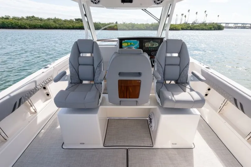 Slide: The Image of The image shows the cockpit of a Regal 34 SAV boat with gray seats and a helm station. - 42