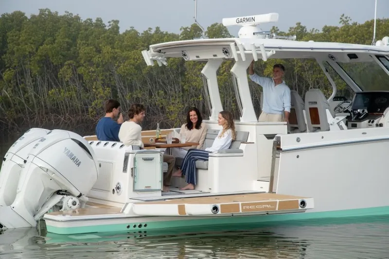 Slide: The Image of A group of people sits on a luxurious boat floating on calm water. - 6