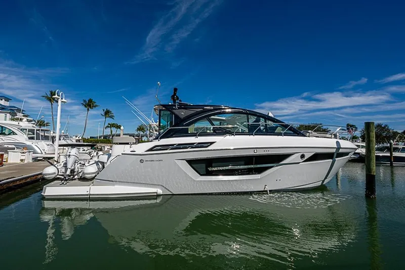 The Image of 2025 Cruisers Yachts 50 Cantius docked in a sunny marina setting. - 0