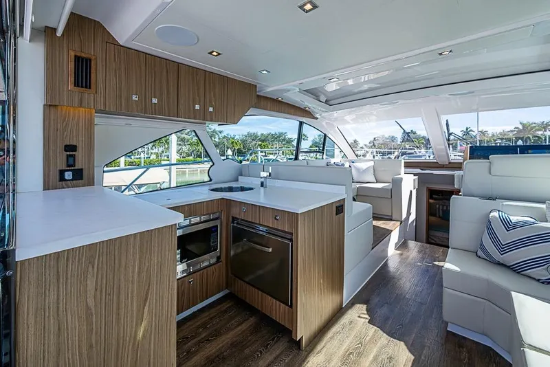Slide: The Image of Luxurious interior of 2025 Cruisers Yachts 50 Cantius with modern kitchen and seating area. - 10