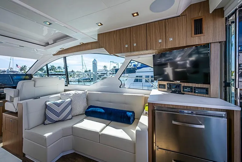 Slide: The Image of Luxurious interior of 2025 Cruisers Yachts 50 Cantius with modern seating and entertainment system. - 11