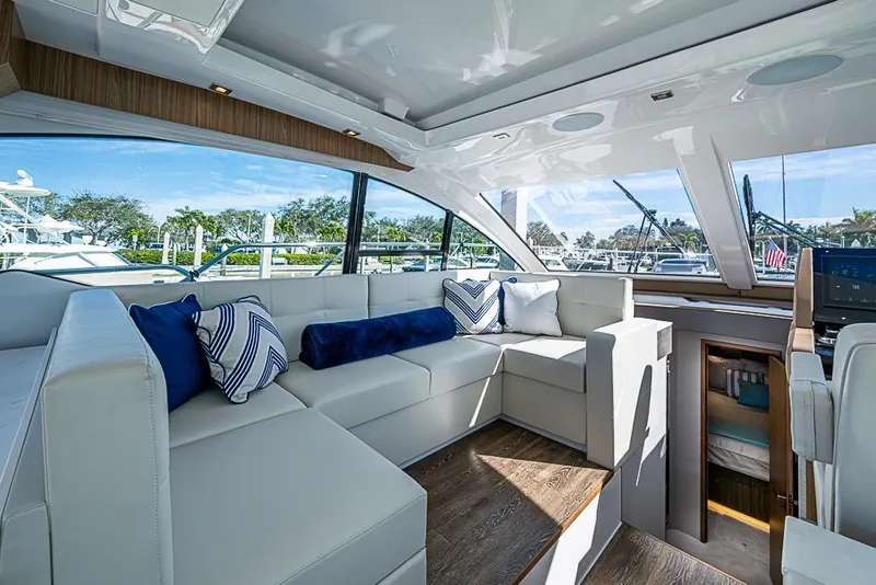 Slide: The Image of Luxurious interior of 2025 Cruisers Yachts 50 Cantius with plush seating and scenic windows. - 14