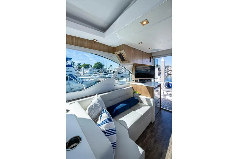 Slide: The Image of Luxurious interior of 2025 Cruisers Yachts 50 Cantius with modern seating and marina view. - 15