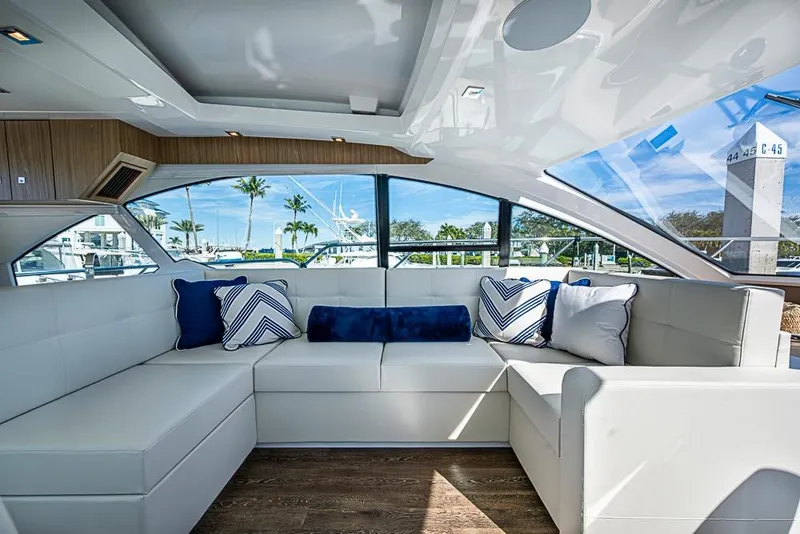 Slide: The Image of Luxurious interior of 2025 Cruisers Yachts 50 Cantius with plush seating and scenic windows. - 16