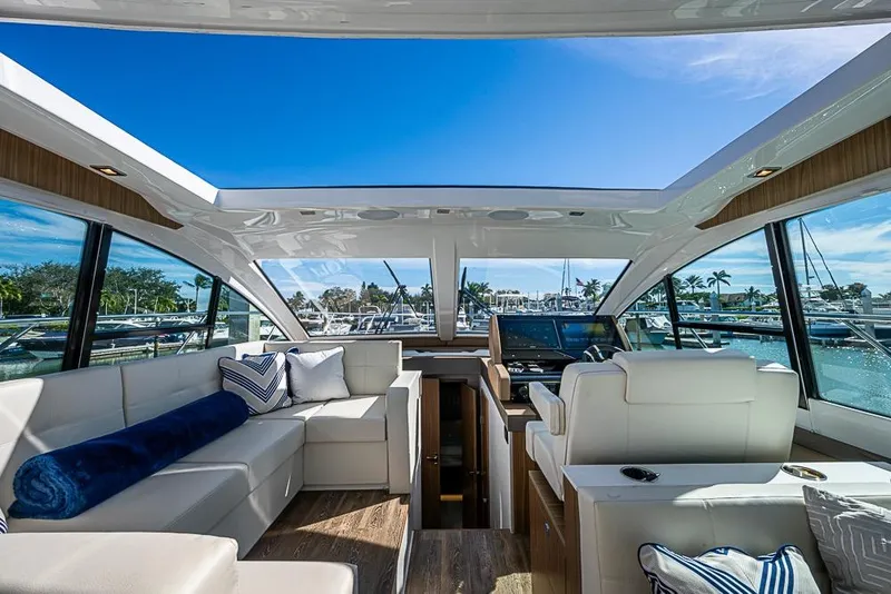 Slide: The Image of Luxurious interior of 2025 Cruisers Yachts 50 Cantius with panoramic windows and plush seating. - 17