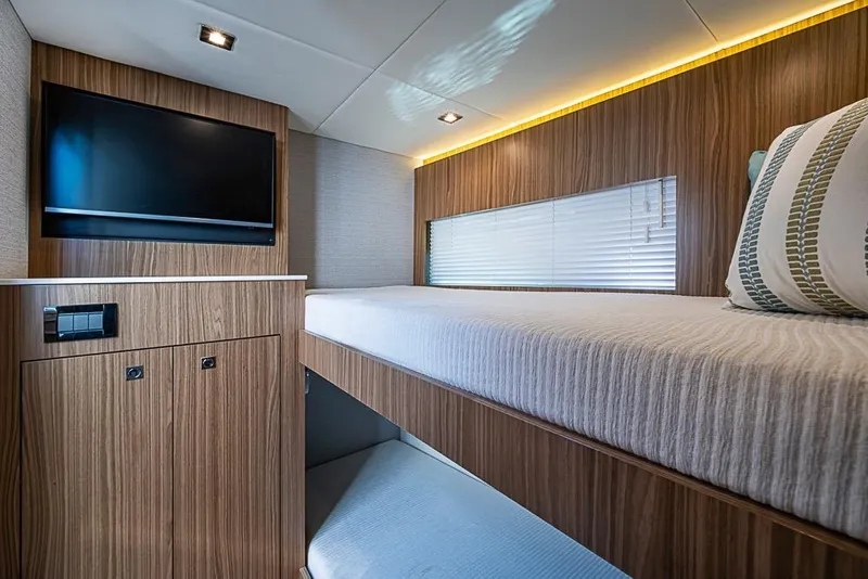 Slide: The Image of Luxurious interior of 2025 Cruisers Yachts 50 Cantius with modern wood finish and cozy bedding. - 34