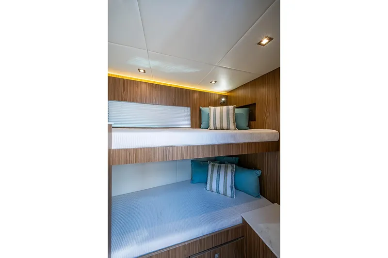 Slide: The Image of Luxurious bunk beds in the 2025 Cruisers Yachts 50 Cantius cabin interior. - 35