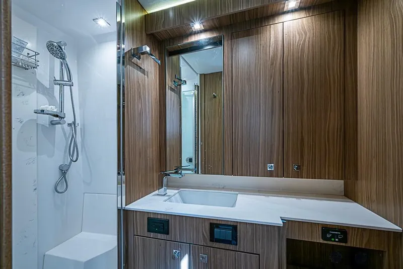 Slide: The Image of Luxurious bathroom in 2025 Cruisers Yachts 50 Cantius, featuring modern wood cabinetry and sleek fixtures. - 36