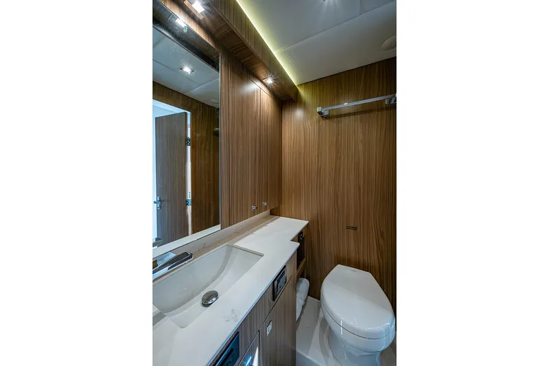 Slide: The Image of Luxurious bathroom in 2025 Cruisers Yachts 50 Cantius, featuring sleek wood paneling and modern fixtures. - 39