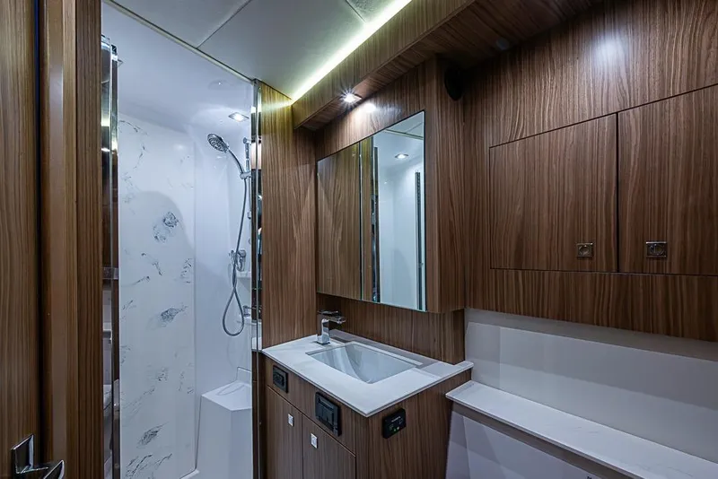 Slide: The Image of Luxurious bathroom interior of 2025 Cruisers Yachts 50 Cantius, featuring wood cabinetry and modern fixtures. - 40