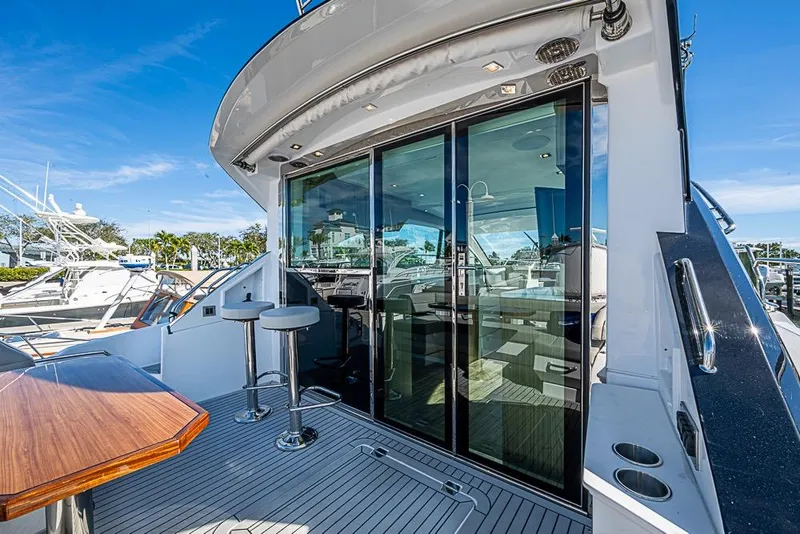 Slide: The Image of 2025 Cruisers Yachts 50 Cantius with sleek deck and modern glass doors. - 45