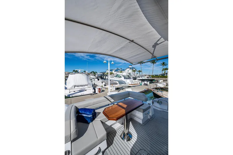 Slide: The Image of Luxurious 2025 Cruisers Yachts 50 Cantius with elegant deck seating and marina view. - 48