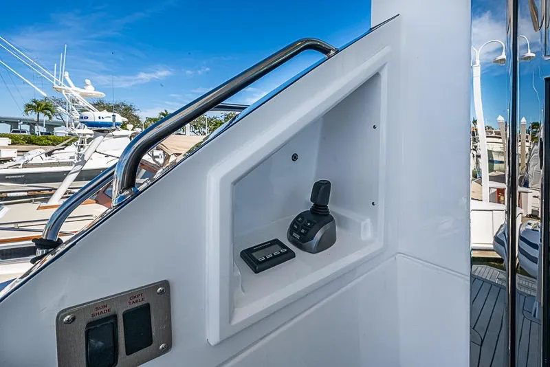 Slide: The Image of Control panel on 2025 Cruisers Yachts 50 Cantius, featuring joystick and switches, dockside view. - 53