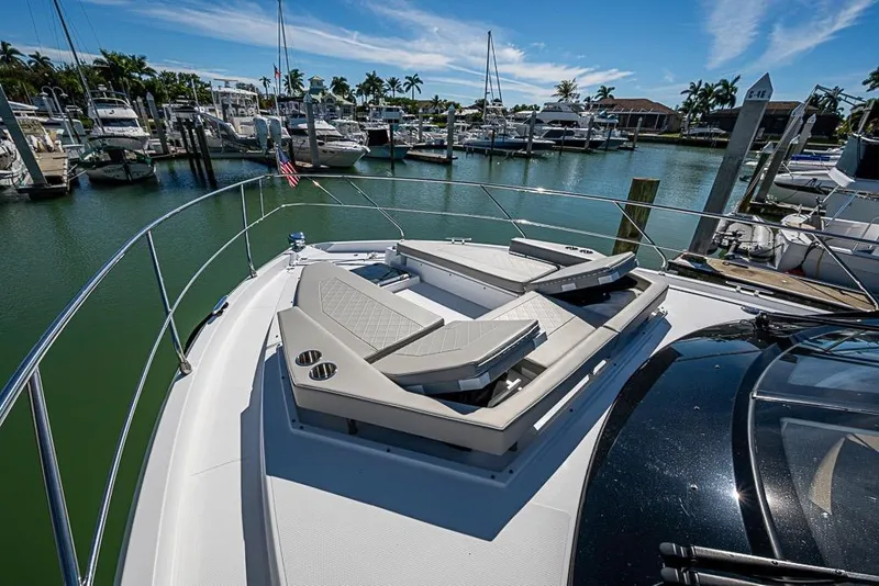 Slide: The Image of Luxurious 2025 Cruisers Yachts 50 Cantius docked, featuring elegant sun loungers on deck. - 57