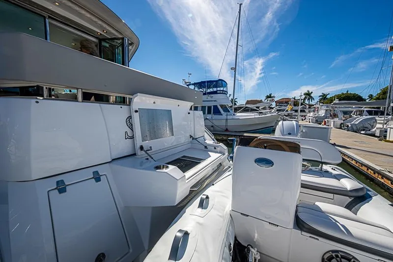 Slide: The Image of 2025 Cruisers Yachts 50 Cantius at marina, showcasing sleek design and modern amenities. - 59