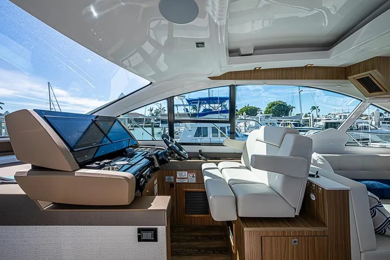 Slide: The Image of Interior of 2025 Cruisers Yachts 50 Cantius, featuring modern helm and luxurious seating. - 6