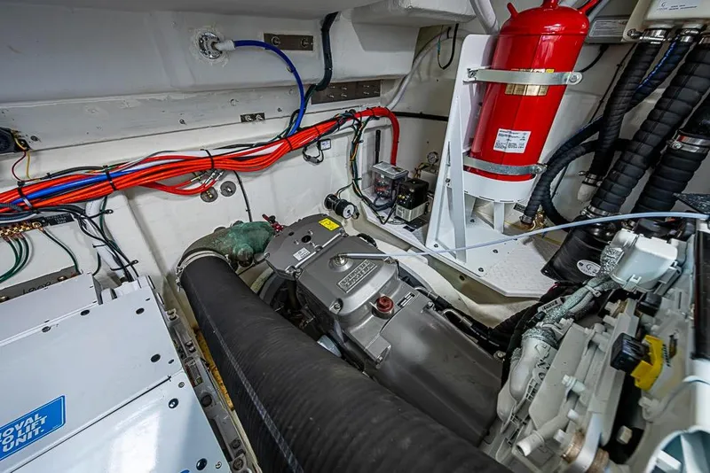 Slide: The Image of Engine room of 2025 Cruisers Yachts 50 Cantius with wiring and fire extinguisher. - 68