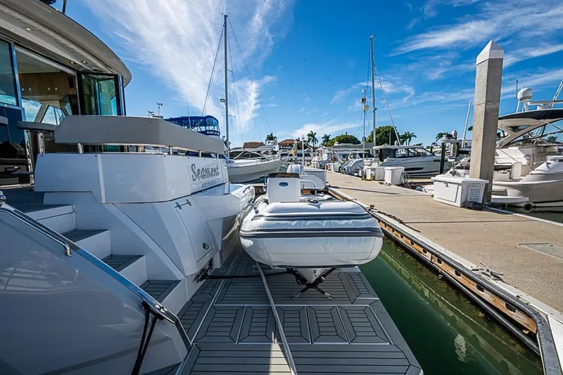 Slide: The Image of 2025 Cruisers Yachts 50 Cantius docked at marina with inflatable boat. - 74