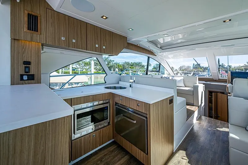 Slide: The Image of Luxurious interior of 2025 Cruisers Yachts 50 Cantius with modern kitchen and seating area. - 8