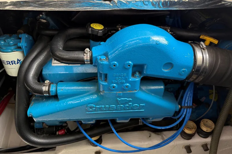Slide: The Image of Engine of a 1995 Tiara Yachts 3100 Open, featuring a blue Crusader motor. - 29