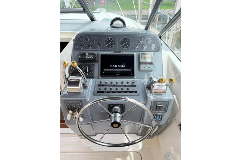 Slide: The Image of Helm of 1995 Tiara Yachts 3100 Open with Garmin navigation system and controls. - 6