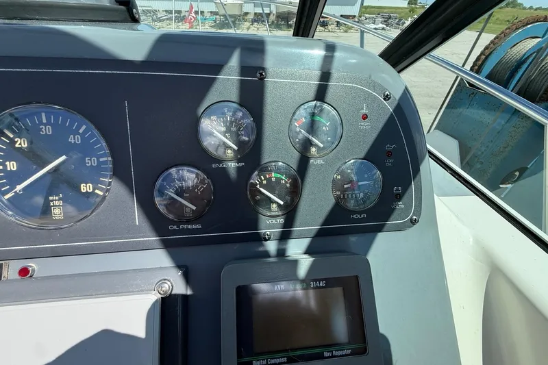 Slide: The Image of Dashboard of a 1995 Tiara Yachts 3100 Open, featuring gauges and controls. - 19