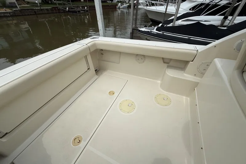 Slide: The Image of 1995 Tiara Yachts 3100 Open boat deck, featuring spacious seating and storage compartments. - 2
