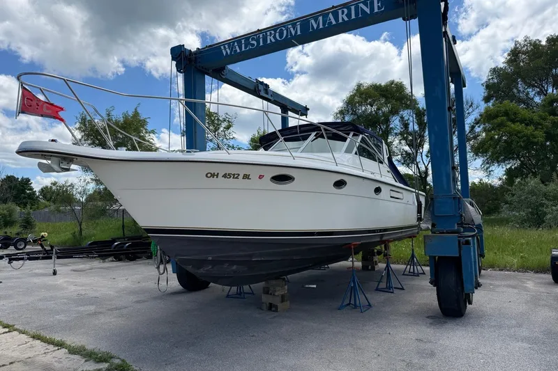 Slide: The Image of 1995 Tiara Yachts 3100 Open on lift at Walstrom Marine, ready for maintenance. - 2