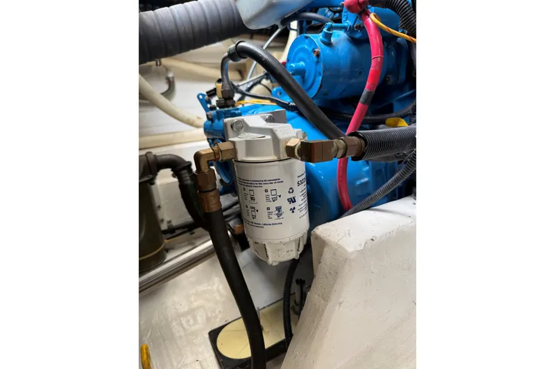 Slide: The Image of Engine compartment of a 1995 Tiara Yachts 3100 Open, showcasing mechanical components and wiring. - 32