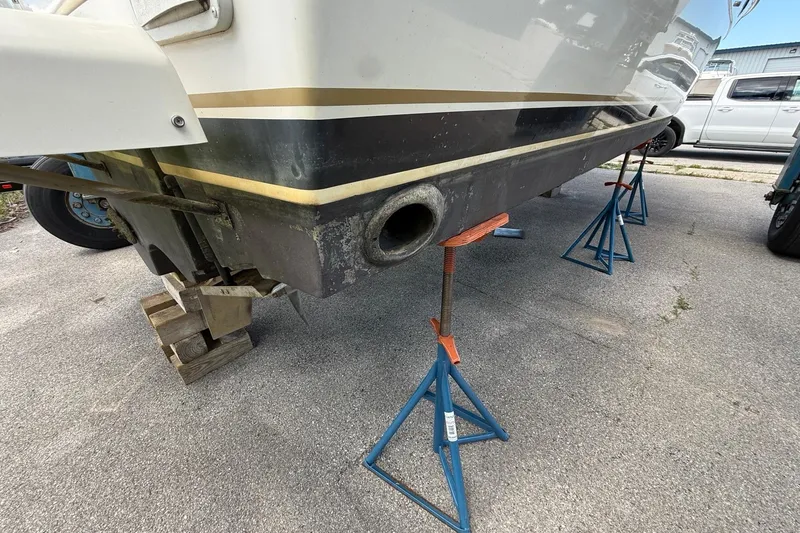 Slide: The Image of 1995 Tiara Yachts 3100 Open on stands, showing hull and exhaust detail. - 9