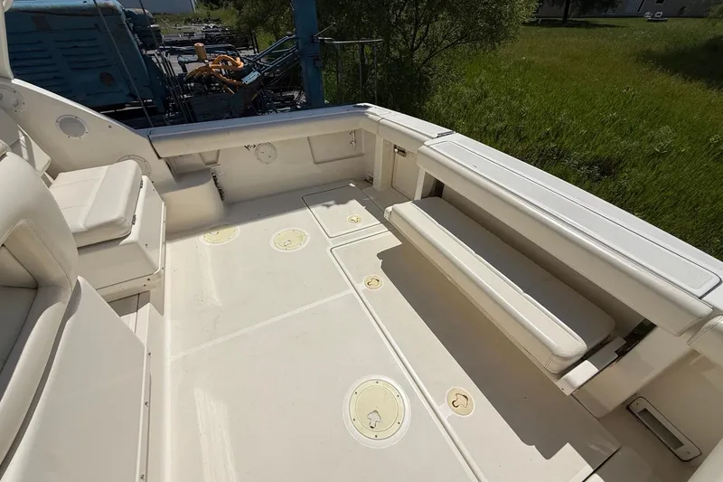 Slide: The Image of 1995 Tiara Yachts 3100 Open boat deck with white seating and storage compartments. - 13