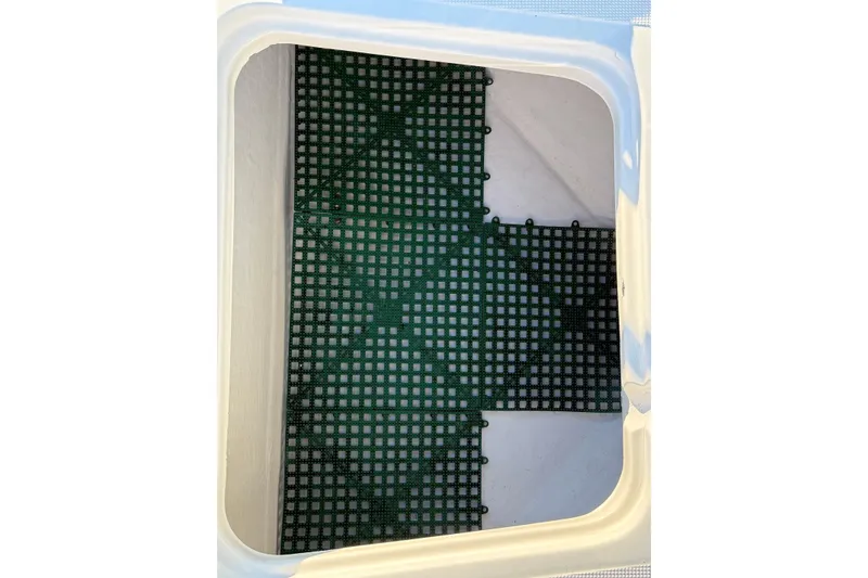 Slide: The Image of Storage compartment with green grid mat in 1995 Tiara Yachts 3100 Open. - 7