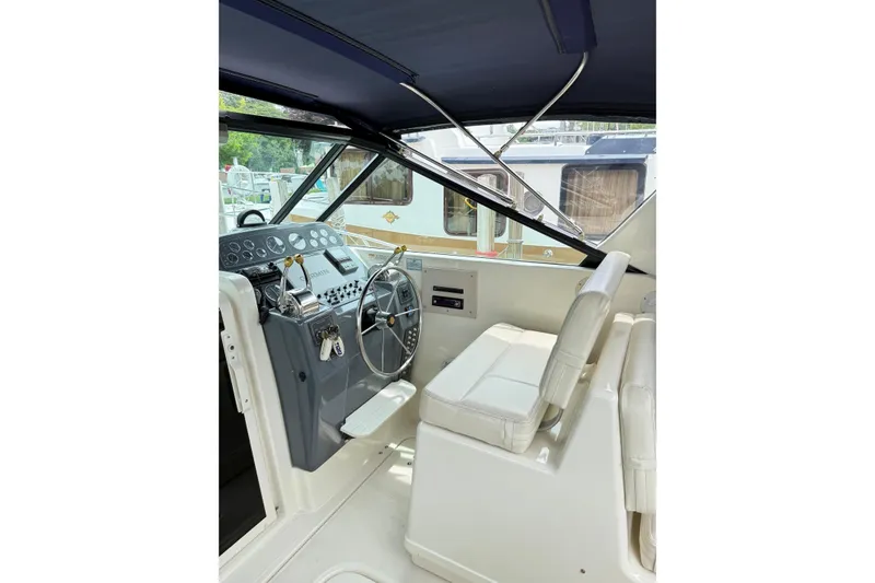 Slide: The Image of Interior of 1995 Tiara Yachts 3100 Open, featuring helm and seating area. - 5