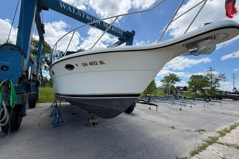 Slide: The Image of 1995 Tiara Yachts 3100 Open on lift at Walstrom Marine, clear sky background. - 3