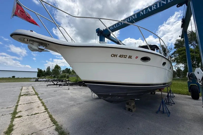 Slide: The Image of 1995 Tiara Yachts 3100 Open on stands, outdoor setting, clear sky background. - 4