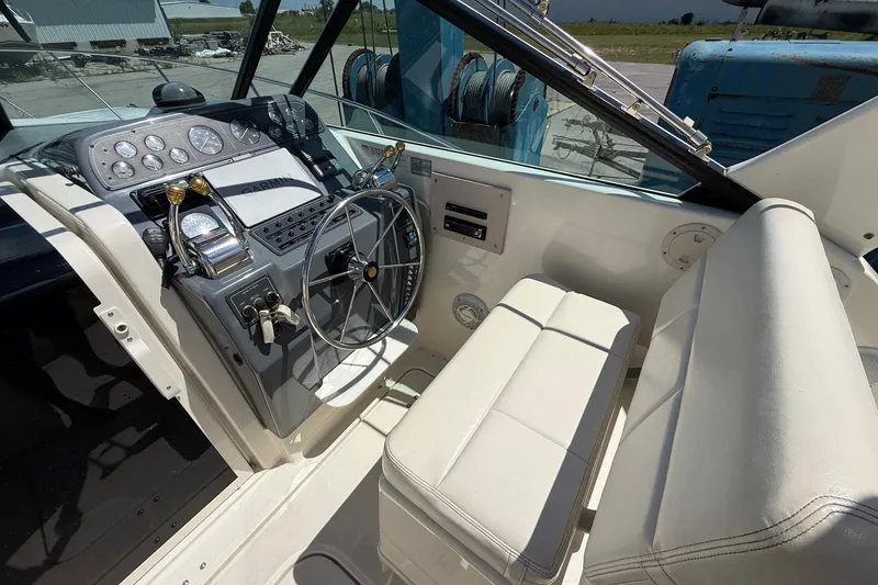 Slide: The Image of 1995 Tiara Yachts 3100 Open cockpit with steering wheel and control panel. - 17