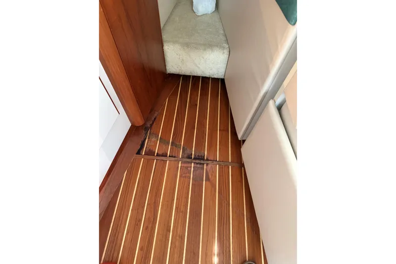 Slide: The Image of 1995 Tiara Yachts 3100 Open interior with wooden flooring and carpeted seating area. - 23