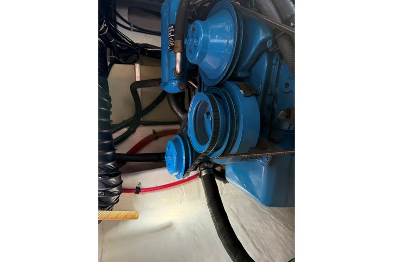 Slide: The Image of Engine components of a 1995 Tiara Yachts 3100 Open, featuring blue pulleys and belts. - 30