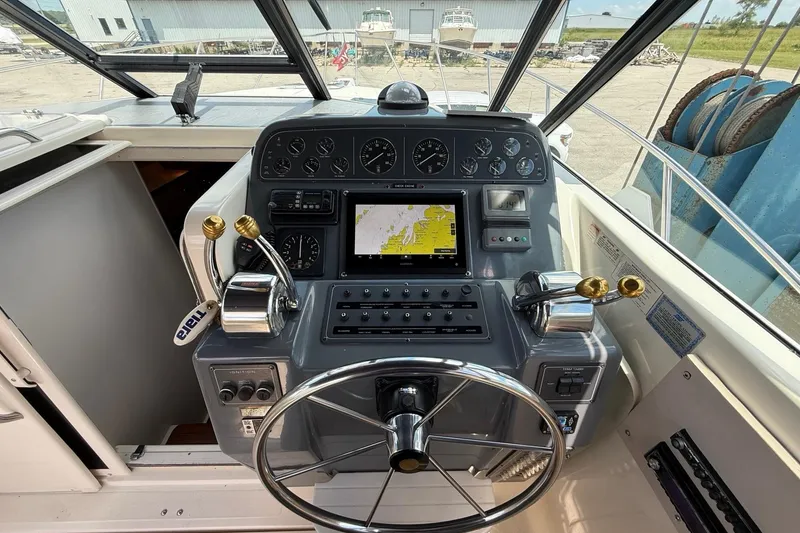 Slide: The Image of Helm of 1995 Tiara Yachts 3100 Open with navigation instruments and steering wheel. - 20