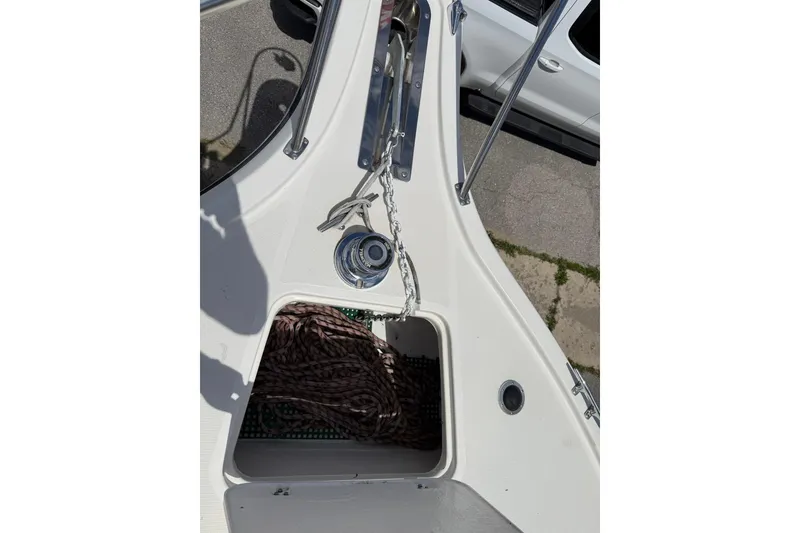 Slide: The Image of 1995 Tiara Yachts 3100 Open bow with anchor chain and storage compartment. - 6