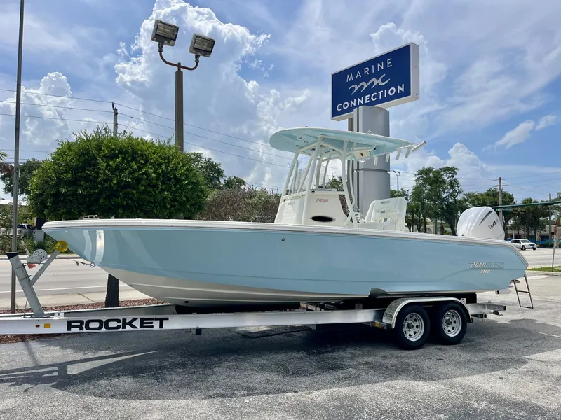 The Image of A 2027 Pathfinder 2400 Hybrid boat on a trailer in front of a Marine Connection sign. - 1