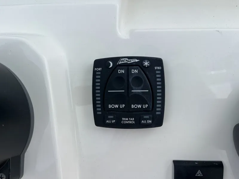 Slide: The Image of Trim tab control on a boat with up and down buttons for bow and stern. - 13