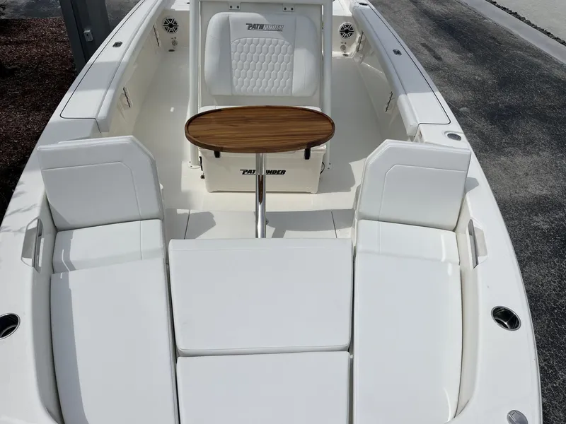 Slide: The Image of The image shows the cockpit of a Pathfinder 2400 Hybrid boat with white seating and a wooden table. - 19