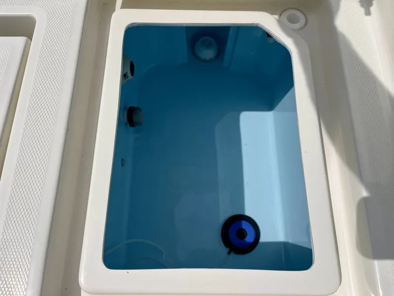 Slide: The Image of An open compartment on a boat with blue water inside. - 24