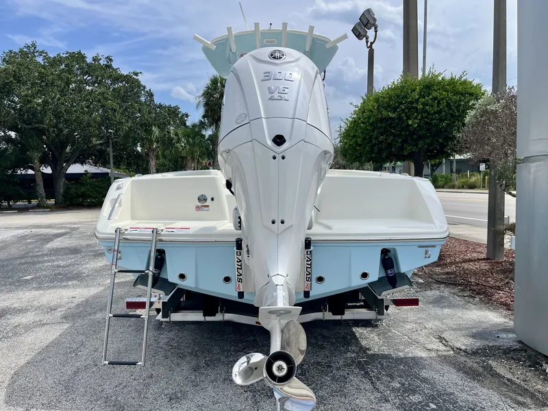 Slide: The Image of Rear view of a Pathfinder 2400 Hybrid boat with a large outboard motor. - 4