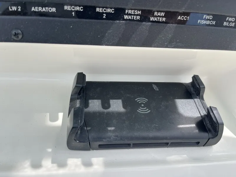Slide: The Image of A charger on a boat with various switches above it. - 14
