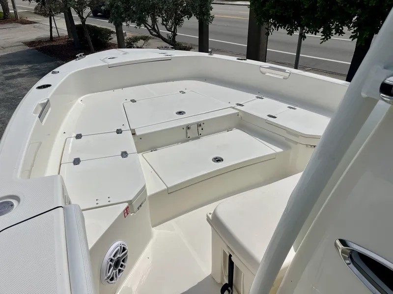 Slide: The Image of The image shows the deck of a 2027 Pathfinder 2400 Hybrid boat with storage and a speaker. - 15